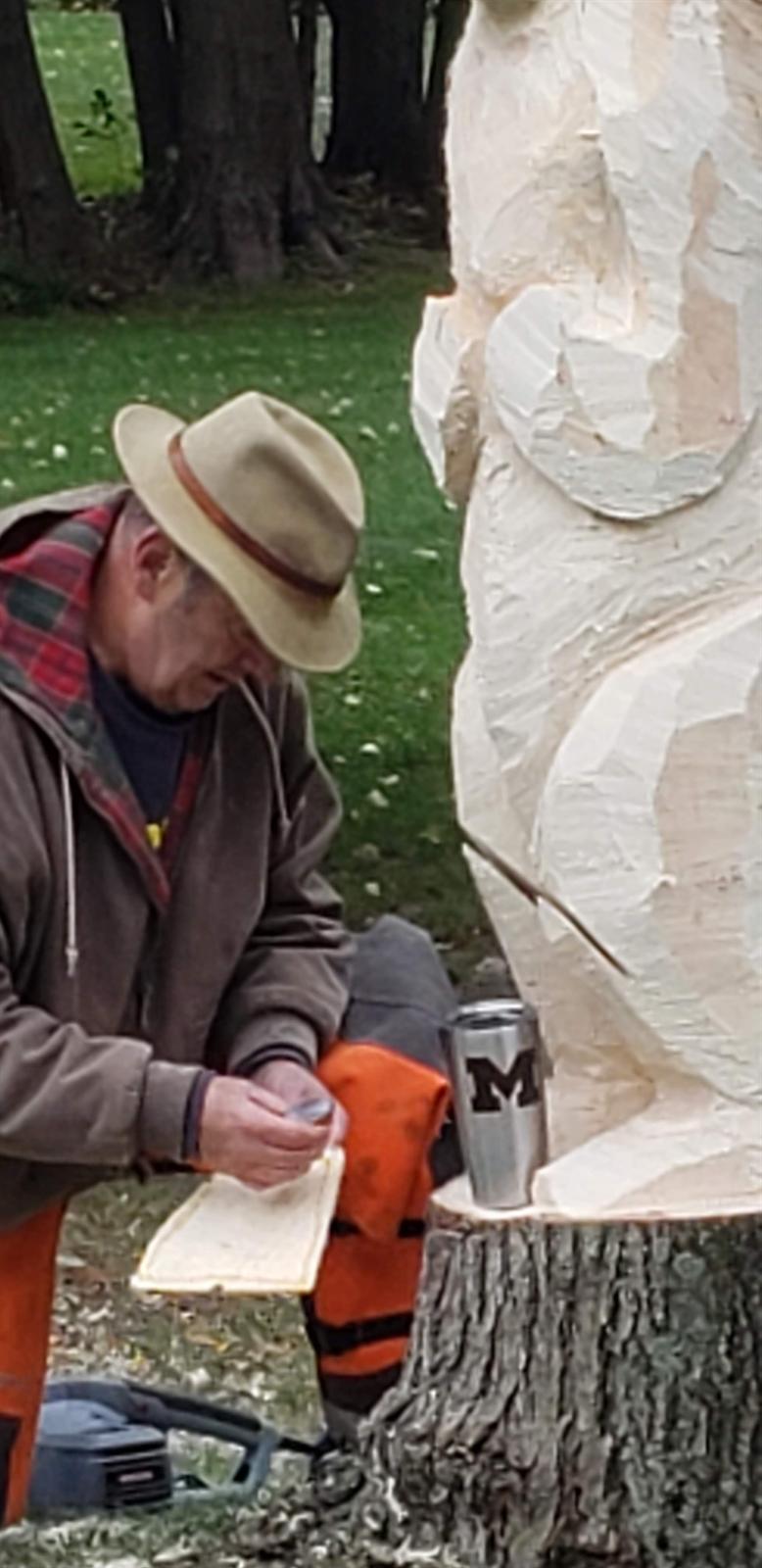 Todd Bredin beside the partly carved bear